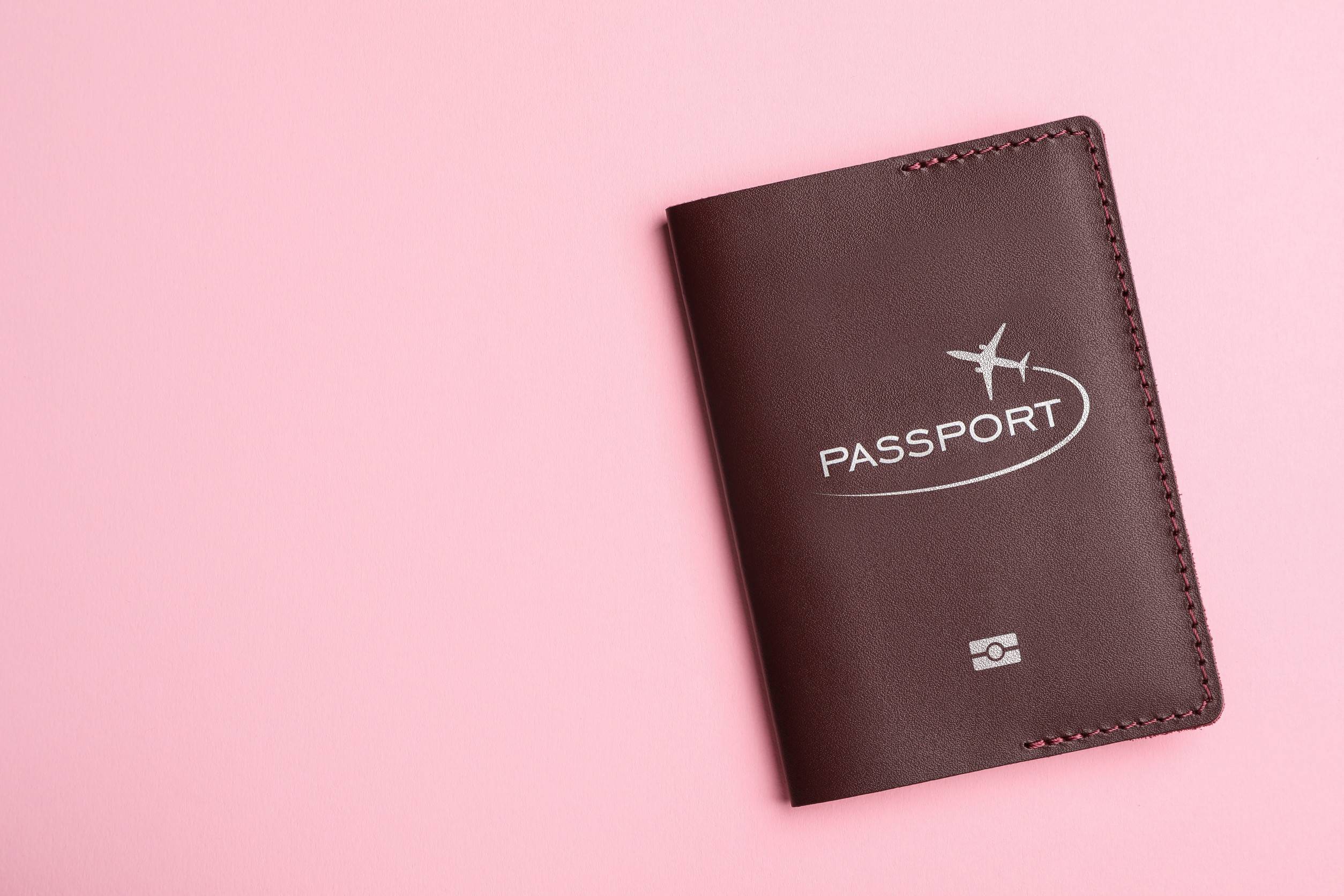 A passport in a brown leather case