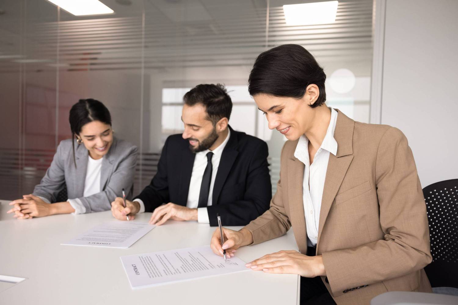 Business Partners Signing Agreement In Office Meeting