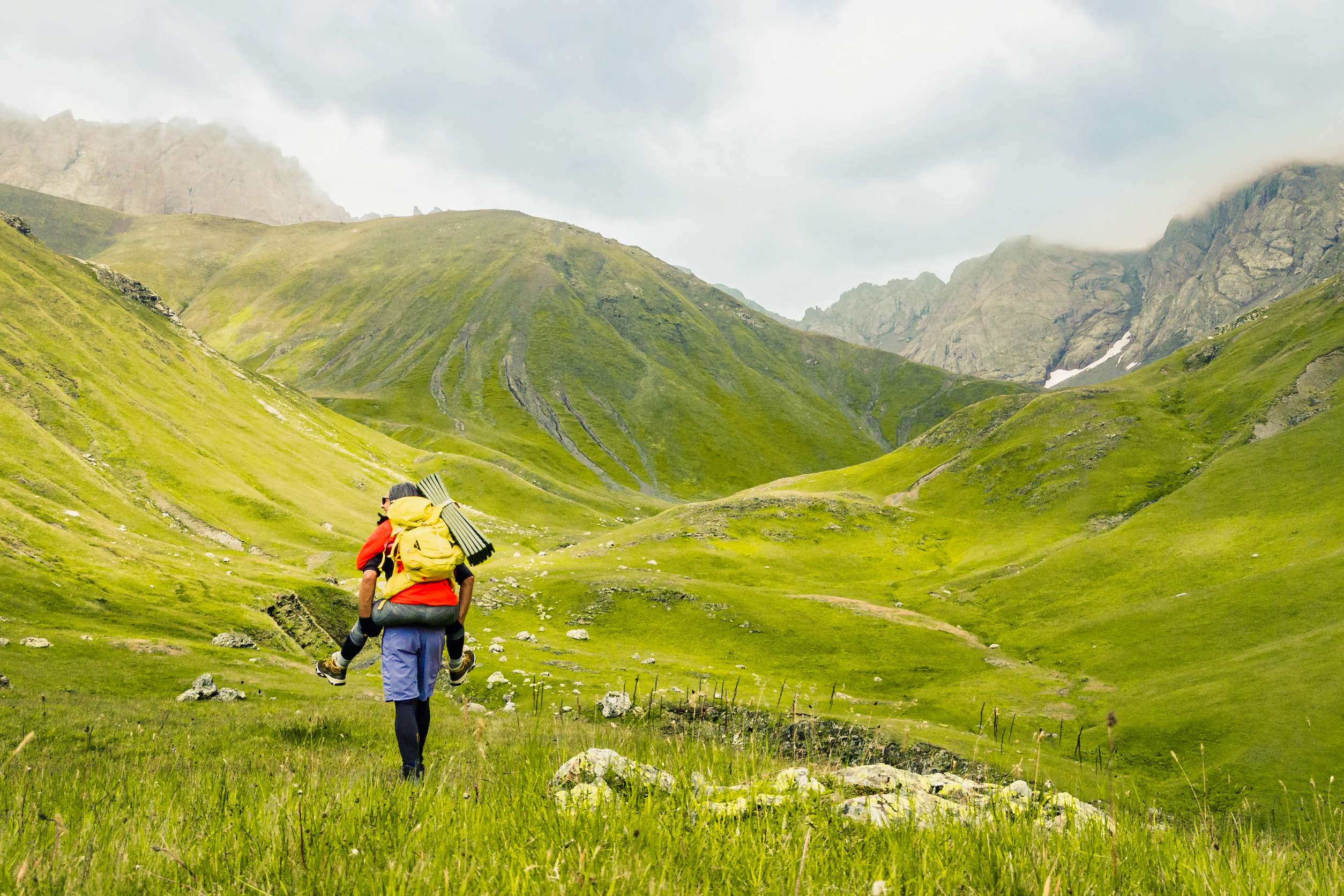 Back view of sporty Caucasian couple hikers having fun hiking