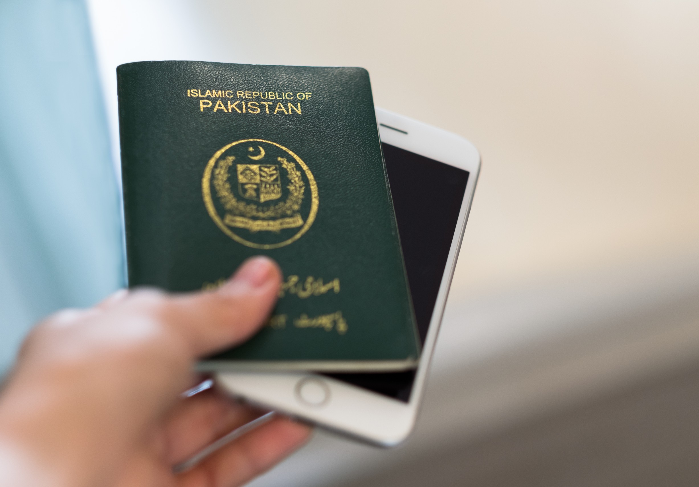 Hand holds Pakistan passport