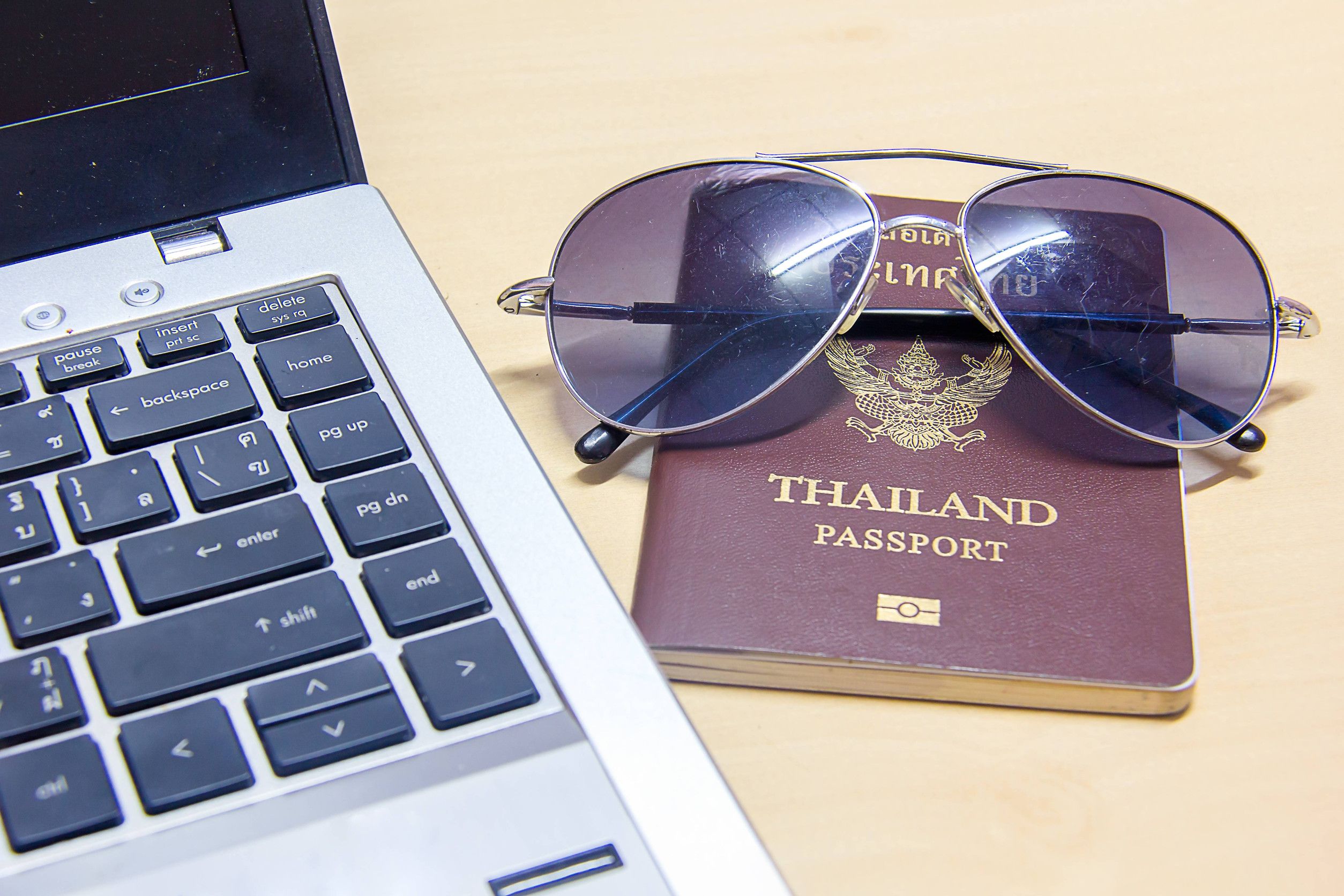 Passport, glass, and laptop