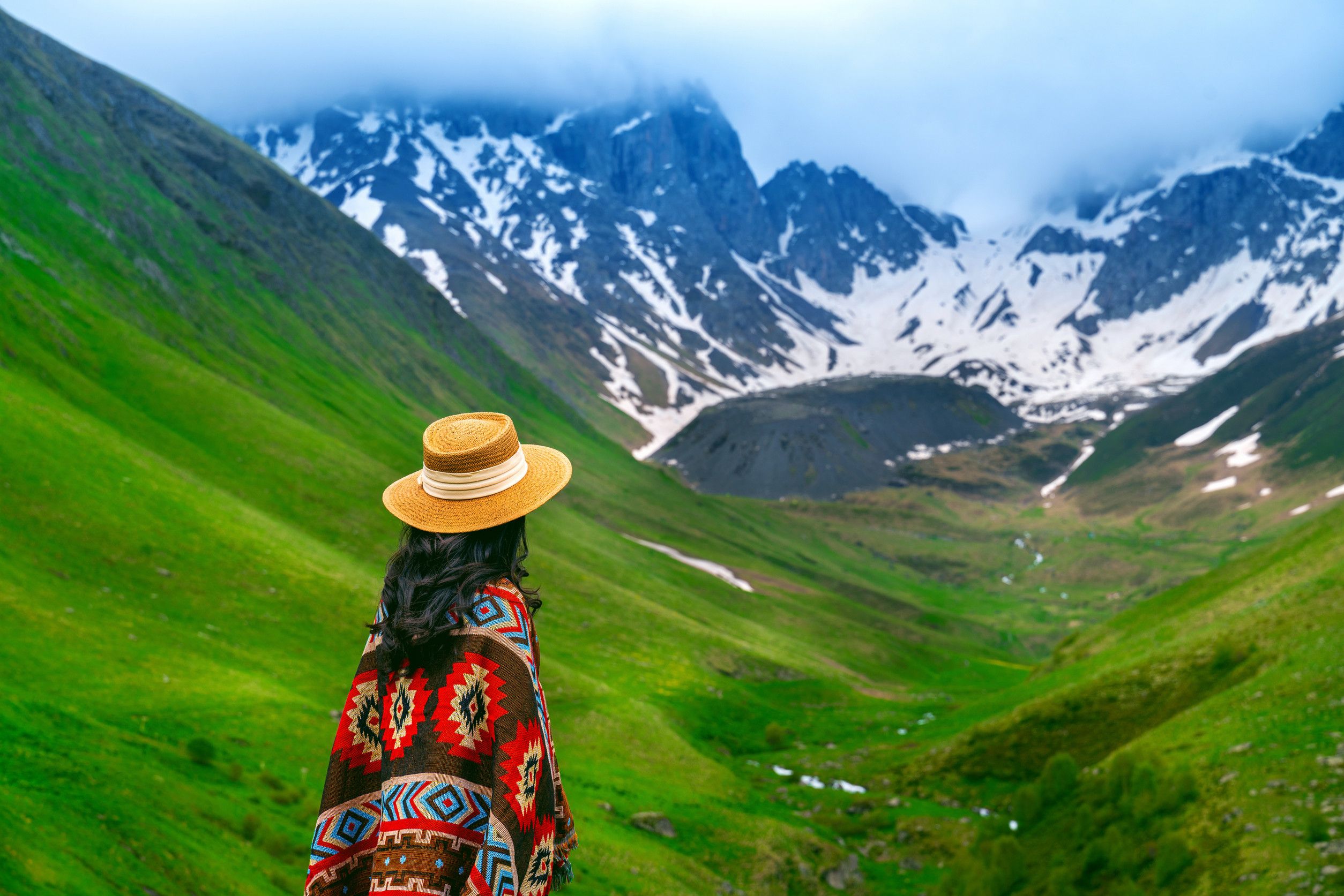 Tourist enjoying the view of mountain valley landscape in Juta, Georgia